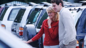 Should you buy a new or secondhand car couple looking at cars